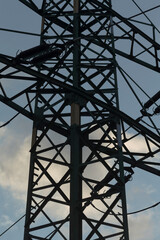 A remarkably tall metal structure towering above, set against a clear blue sky that stretches...