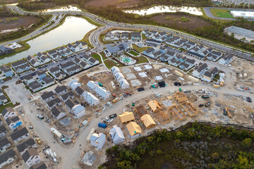 Wooden houses under construction in new developing suburban area. Development of residential housing in American suburbs. Real estate market in the USA