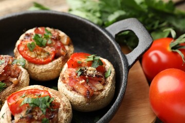 Tasty stuffed mushrooms served on table, closeup