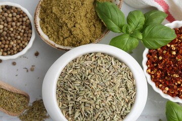 Different aromatic spices on white table, closeup