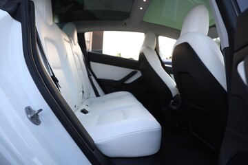 Modern car interior with seats and safety belts, view from outside