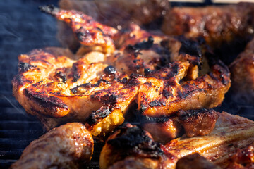 Pork chops, steak, sausages on barbecue grill