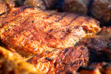 Pork chops, steak, sausages on barbecue grill