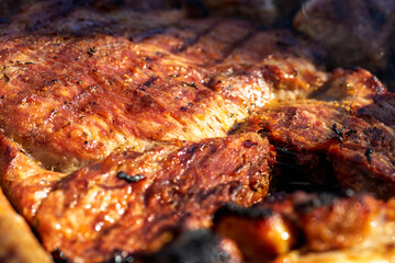 Pork chops, steak, sausages on barbecue grill