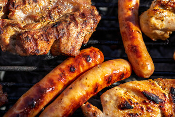 Pork chops, steak, sausages on barbecue grill