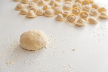 Raw homemade dumplings dusted with flour.