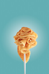 Golden pancakes on a fork against a vibrant blue background.