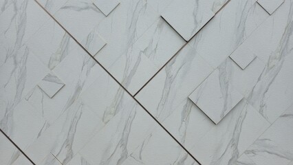 Grey granite tiles that are elegant and opulent are placed diagonally across the walls. The large...