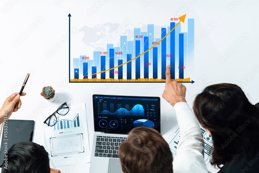 Poster A diverse business team collaboratively analyzing a growth chart while utilizing modern technology in an office setting, highlighting teamwork and data insights. Amity