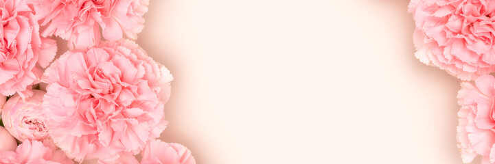 Banner with pink carnation and rose flowers on a beige background. Place for text.
