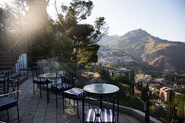 woman on terrace overlooking mountain towns