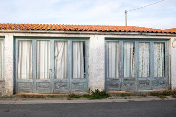 two door entrance facade of an old store converted into a dwelling ancient dilapidated apartment