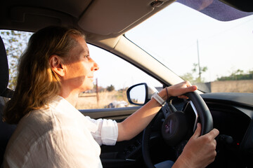 happy woman drriving a car road trip