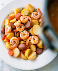Frogmore Stew Assembly, Beaufort, South Carolina – Traditional coastal dish of shrimp, sausage, corn, and red potatoes served hot and rustic for southern gatherings and seafood-focused menus