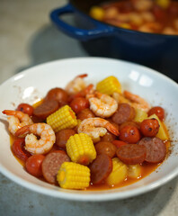 Frogmore Stew Assembly, Beaufort, South Carolina – Traditional coastal dish of shrimp, sausage, corn, and red potatoes served hot and rustic for southern gatherings and seafood-focused menus