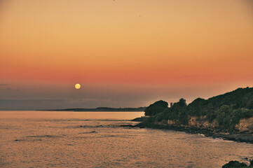 Night sky with full moon above the Tasman Sea and the west coast of North Island, New Zealand, close to New Plymouth
