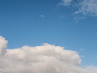 Cloudy blue sky. Background for design and replacement. Warm summer vibe.