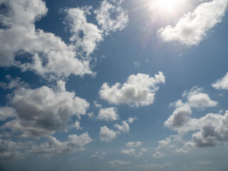Cloudy blue sky. Background for design and replacement. Warm summer vibe.