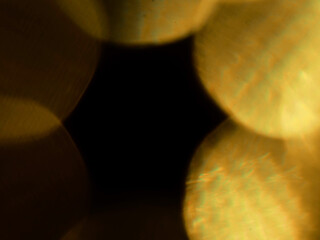 Abstract bokeh scene. Golden light leaks on black color background for design. Light effect.