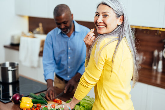 cinematic image of a multiethnic senior couple.