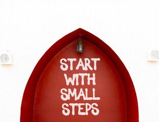 Start with small steps symbol. Concept words phrase Start with small steps on beautiful brown wall....