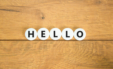 Hello symbol. Concept word Hello on beautiful white pills circles. Beautiful wooden table wooden background. Business lifestyle hello concept. Copy space.