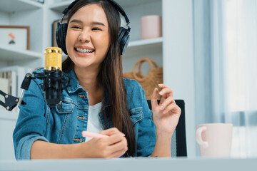 Host channel Asian influencer talking in broadcast streaming online wearing headset on social media...