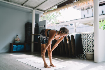 Woman smiling gently in halfway lift yoga pose, engaged in conscious movement and breath connection...