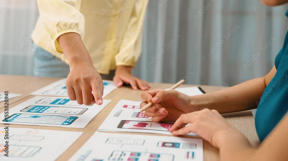 Poster panorama video of startup company employee planning on user interface prototype for mobile applicati