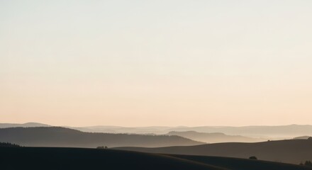 Misty mountain landscape at dawn with various shades of brown and blue in the sky. Concept for peace and serenity.