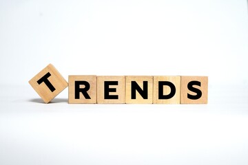 The word "TRENDS" spelled out using wooden blocks with bold black letters on a clean white background.