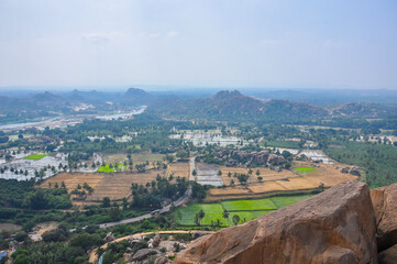 Climb to the top of the mountain, which offers a unique view of the beauty of the historical city of Hampi