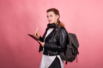 Woman with headphones, listening to music, fashion model in studio posing, music genre, smiling, rock, metal music , tablet
