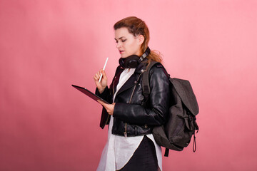 Woman with headphones, listening to music, fashion model in studio posing, music genre, smiling, rock, metal music , tablet