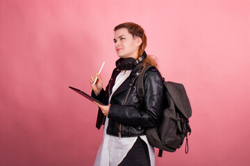 Woman with headphones, listening to music, fashion model in studio posing, music genre, smiling, rock, metal music , tablet