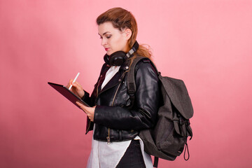 Woman with headphones, listening to music, fashion model in studio posing, music genre, smiling, rock, metal music , tablet