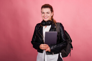 Woman with headphones, listening to music, fashion model in studio posing, music genre, smiling, rock, metal music , tablet