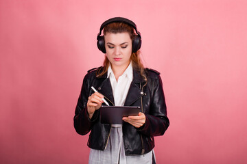 Woman with headphones, listening to music, fashion model in studio posing, music genre, smiling, rock, metal music , tablet