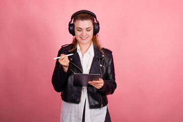 Woman with headphones, listening to music, fashion model in studio posing, music genre, smiling, rock, metal music , tablet