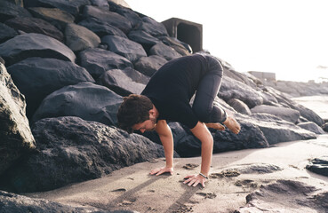Man in arm balance pose hovers in full body control, symbolizing digital era resilience, strength,...