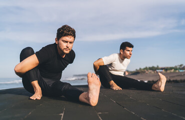Dual arm-bound poses with intense gaze signal structured focus, body compression, and mobility...