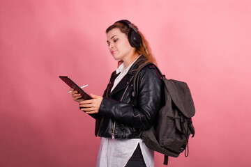 Woman with headphones, listening to music, fashion model in studio posing, music genre, smiling, rock, metal music , tablet
