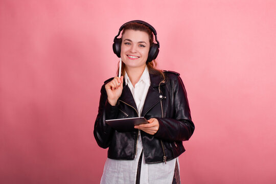 Woman with headphones, listening to music, fashion model in studio posing, music genre, smiling, rock, metal music , tablet