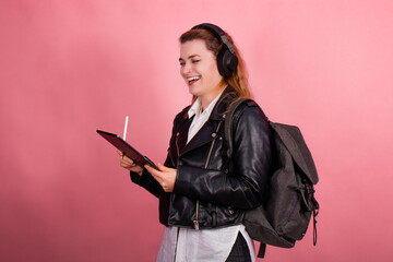 Woman with headphones, listening to music, fashion model in studio posing, music genre, smiling, rock, metal music , tablet