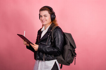 Woman with headphones, listening to music, fashion model in studio posing, music genre, smiling, rock, metal music , tablet