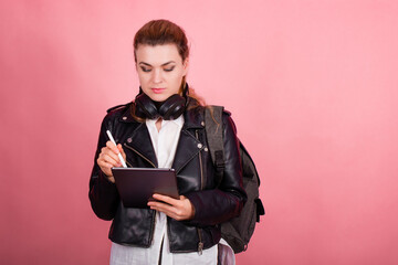 Woman with headphones, listening to music, fashion model in studio posing, music genre, smiling, rock, metal music , tablet