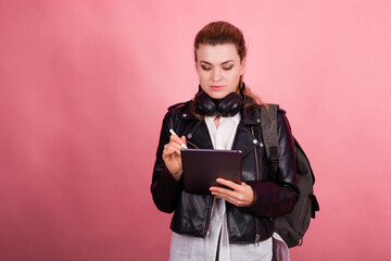 Woman with headphones, listening to music, fashion model in studio posing, music genre, smiling, rock, metal music , tablet