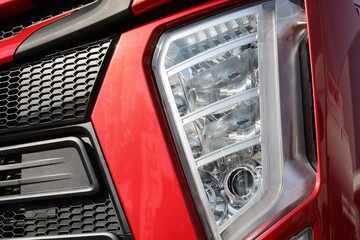 Front view and headlights detail close up on a modern truck.Automotive industry. Photographed in ambiental light.