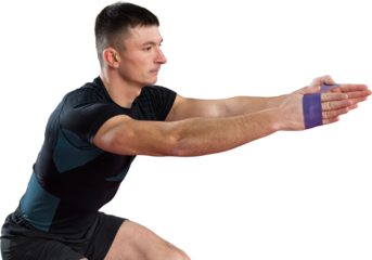 Athletic guy in sportswear and fitness tracker doing exercises in gym.