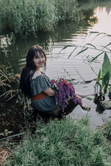 In combination with nature and flowers, harmony with oneself, happy moments, peace and balance. A charming girl in nature.